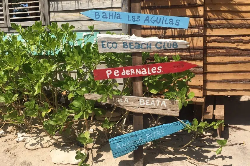 Colorful hand-painted directional signs pointing to the best of Cabo Rojo, Dominican Republic