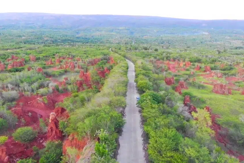 Road cutting through red formations in Hoyo de Pelempito