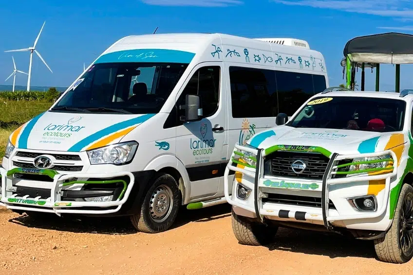 Larimar Ecotours branded van and truck parked on dirt road