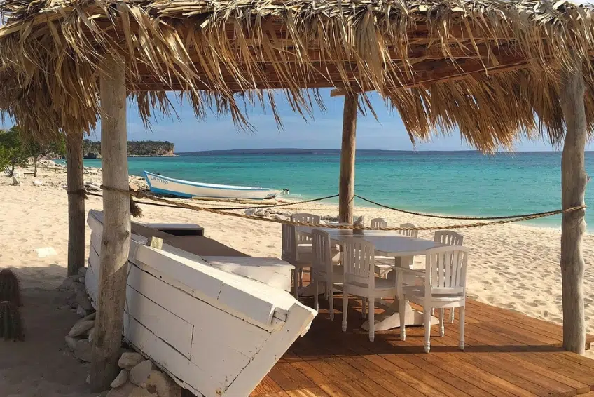 Palapa-covered beachside dining area with ocean view in Cabo Rojo, Dominican Republic