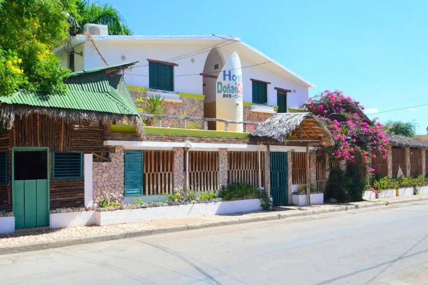 Hostal Dona exterior with thatched palapa entrance in Cabo Rojo, Dominican Republic