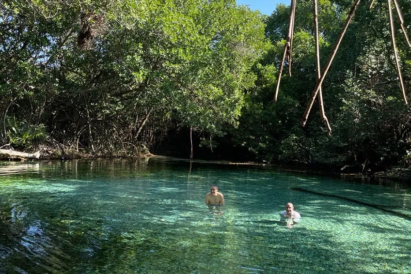Swimmers in clear spring waters at Arroyo Salado