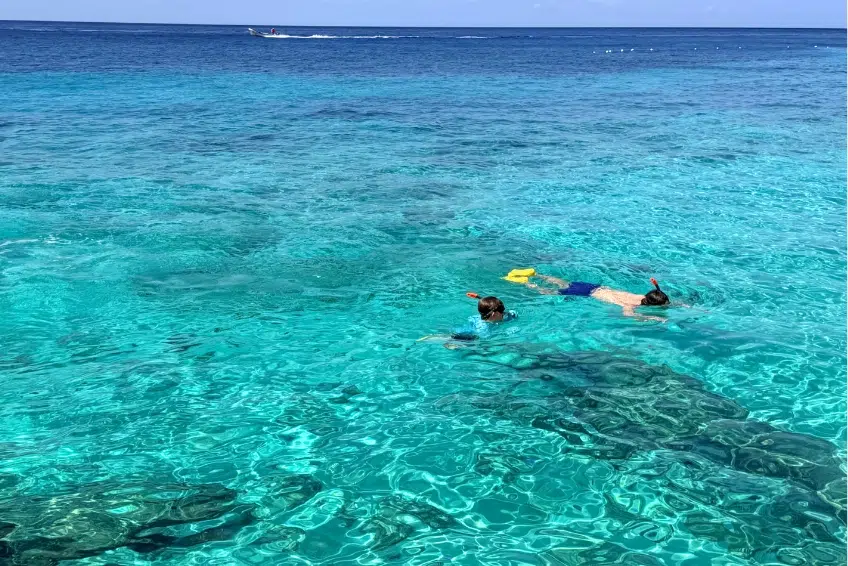Snorkelers exploring turquoise Caribbean water of Bahia de las Aguilas
