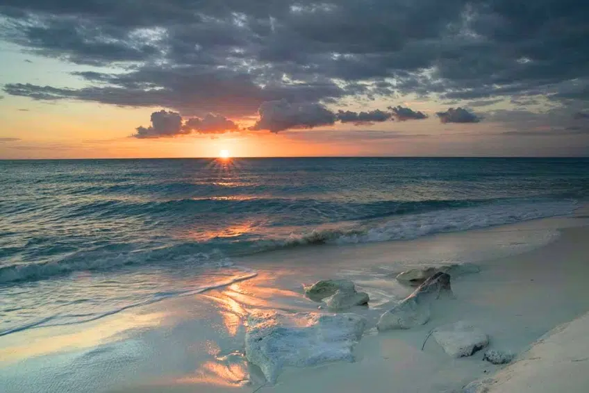 Sunset reflecting on white sand beach shoreline of Bahia de las Aguilas