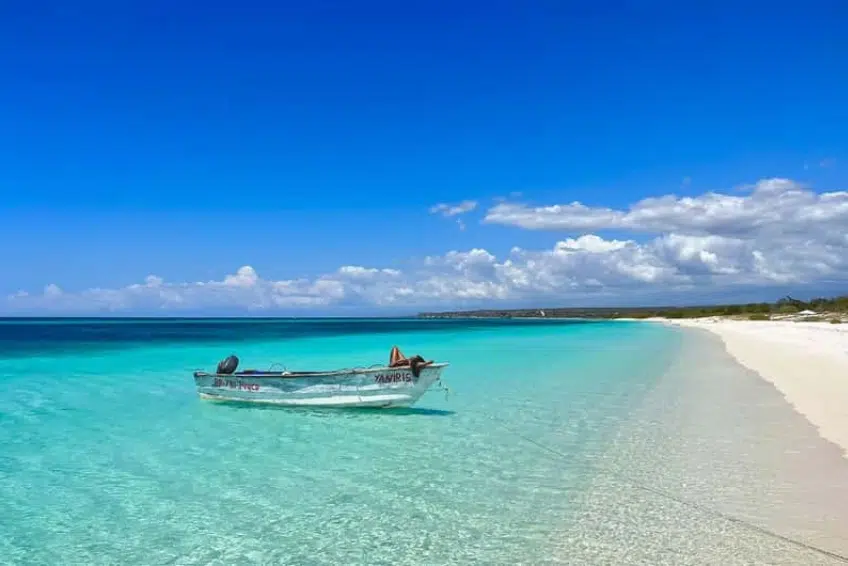Boat moored in turquoise shallows of Bahia de las Aguilas