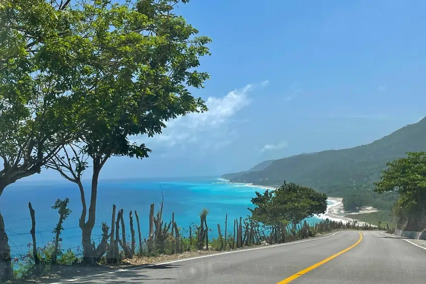Winding Barahona-Enriquillo Coastal Highway overlooking turquoise Caribbean Sea and mountains