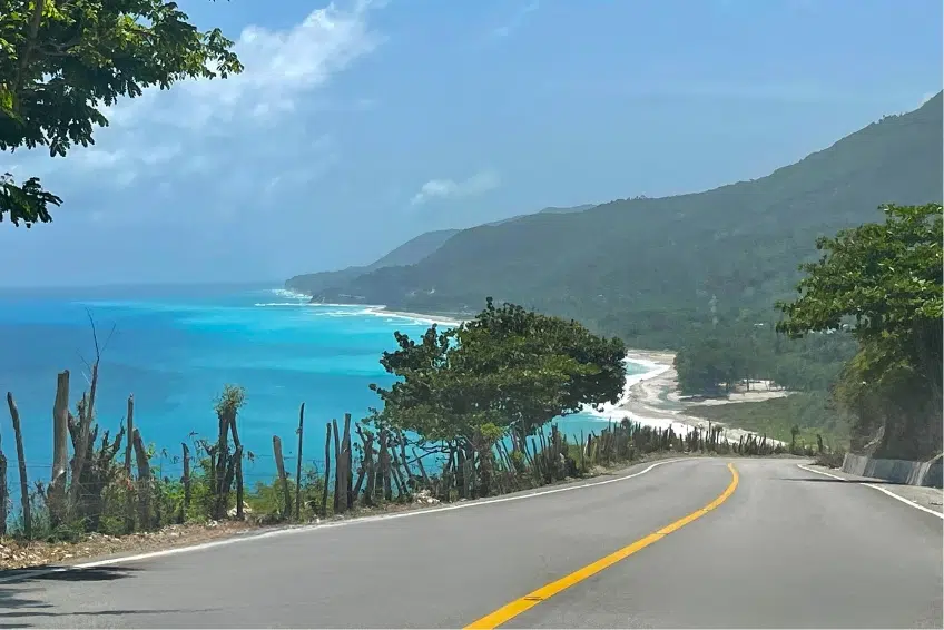 Winding Barahona-Enriquillo Coastal Highway overlooking turquoise Caribbean Sea and mountains
