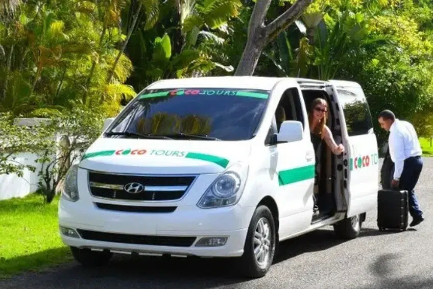 Coco Tours van with passengers and luggage being loaded