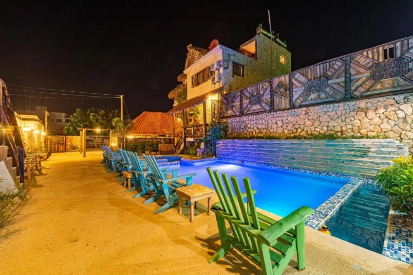 Illuminated hotel pool and lounge chairs at Vista de Aguilas Ecolodge in Pedernales