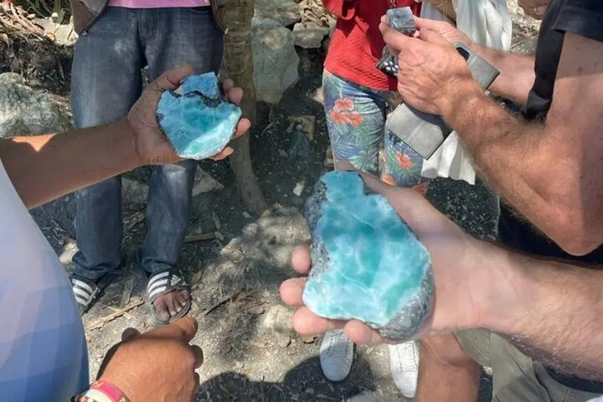 Holding raw blue larimar stones on the mine tour