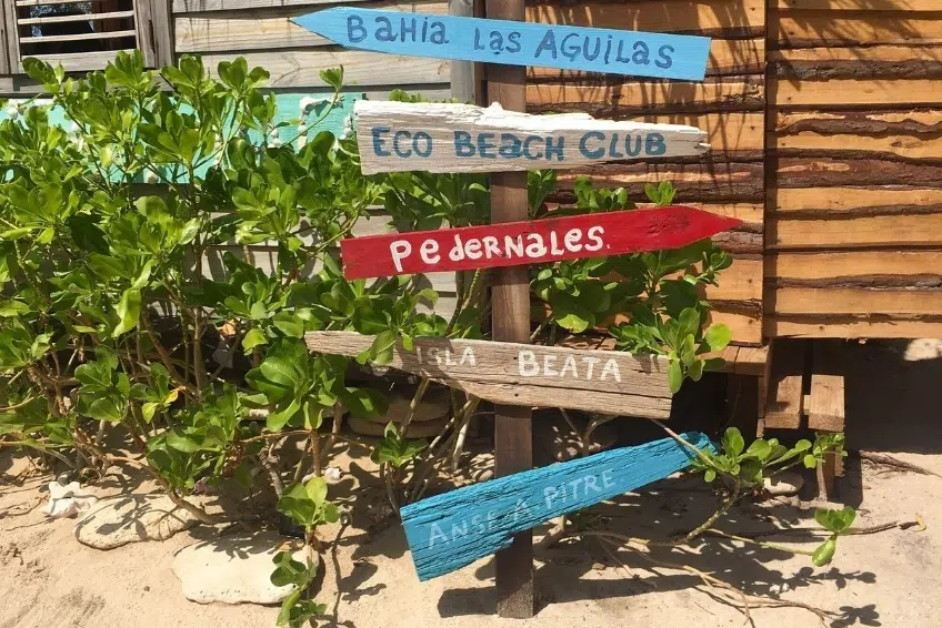 Signs pointing to nearby beaches and towns in Cabo Rojo, Dominican Republic
