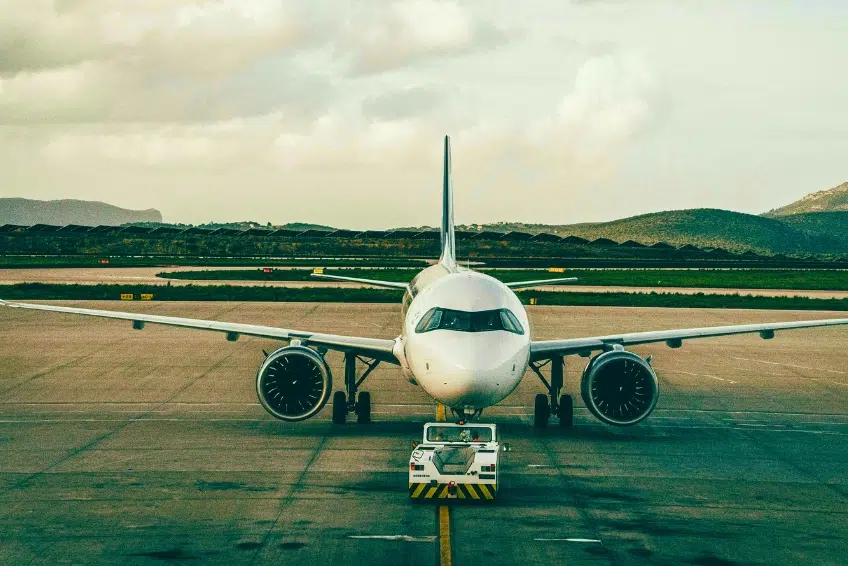 Commercial airplane being towed on airport runway at Pedernales Airport