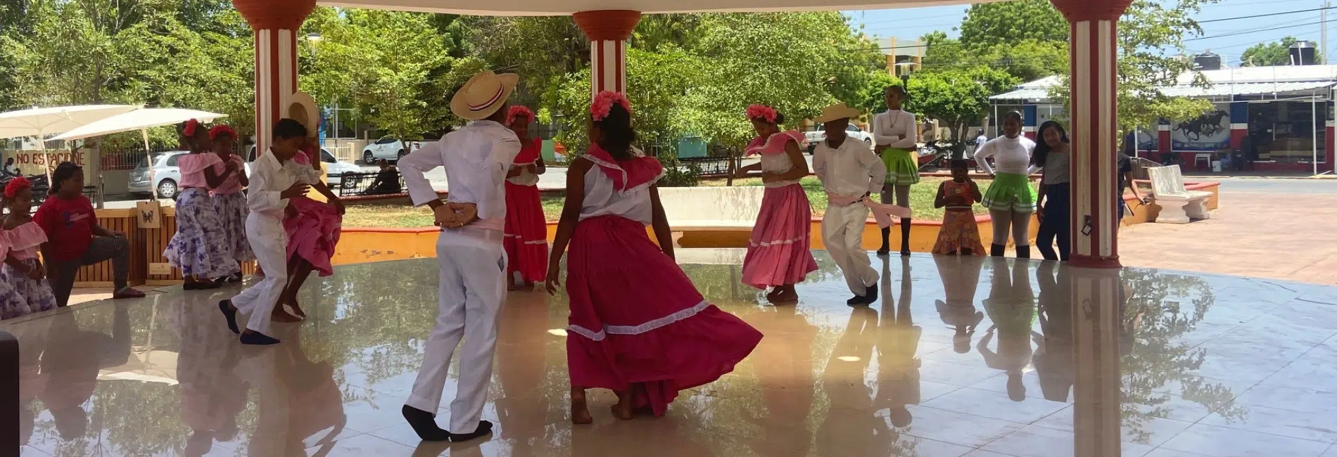 Traditional Dominican folk dancers performing in Pedernales plaza gazebo