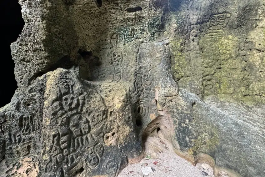 Ancient Taíno petroglyphs carved into cave rock walls
