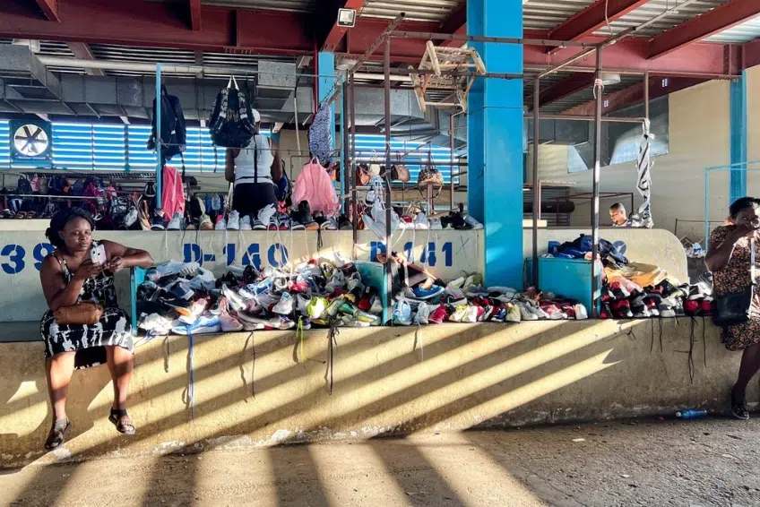 Vendors selling shoes and bags at indoor market stalls Binational Border Market