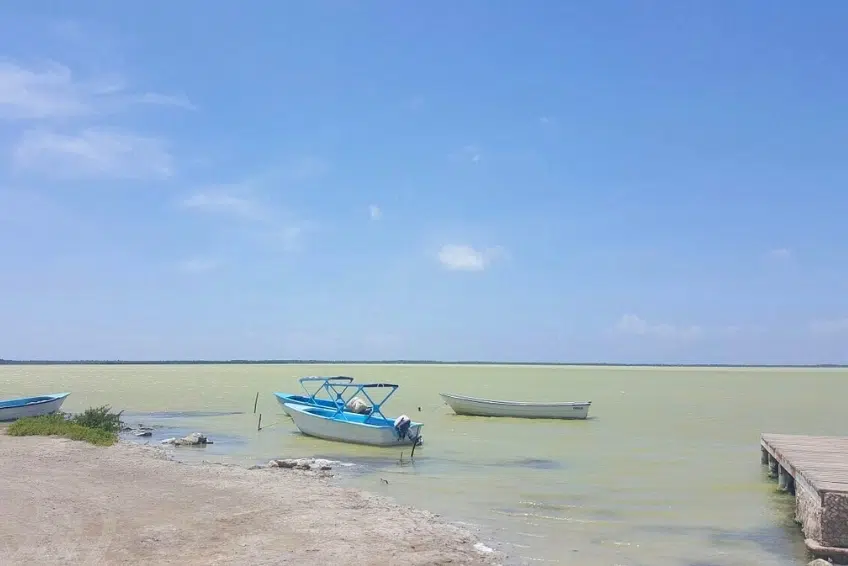 Boats moored on calm waters of Laguna de Oviedo