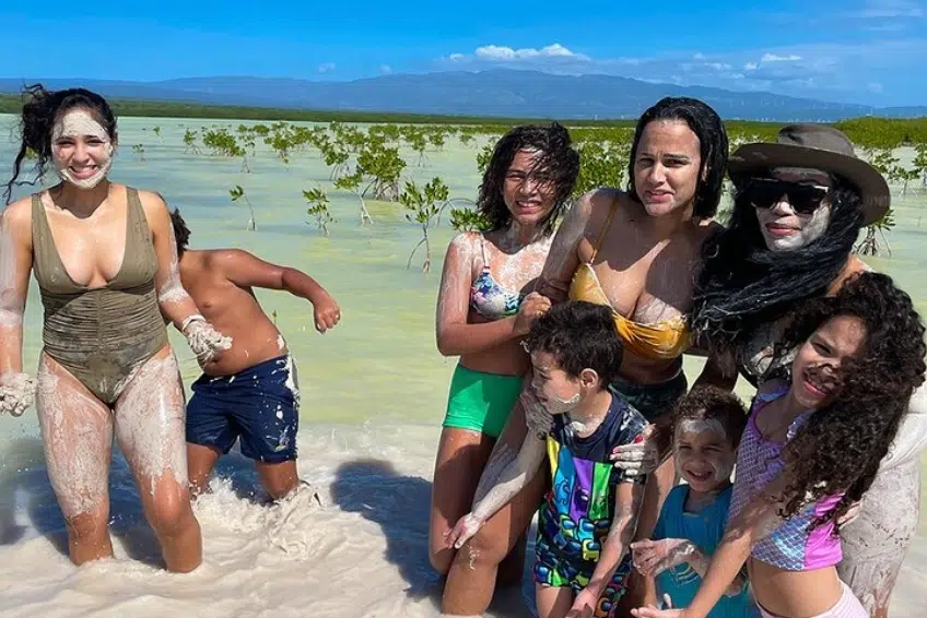 Group laughing and covered in white mud at Laguna de Oviedo