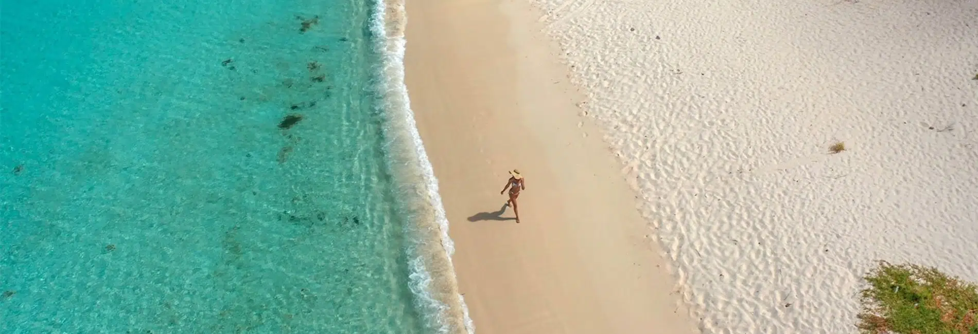Person walking along white sands of Bahia de las Aguilas