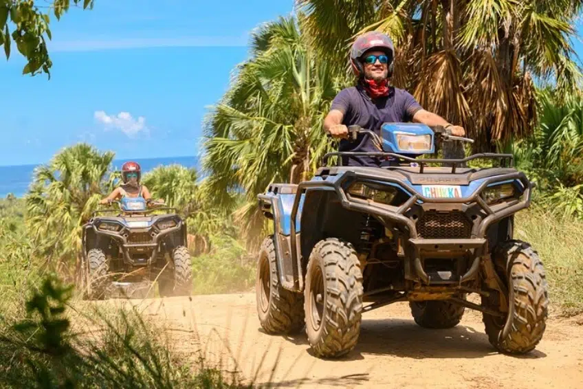 Two riders on ATVs along tropical jungle dirt path - ATV and Buggy Tours