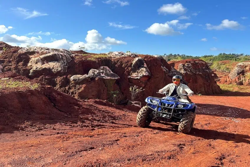 Blue ATV on red dirt trail through rocky terrain - ATV and Buggy Tours