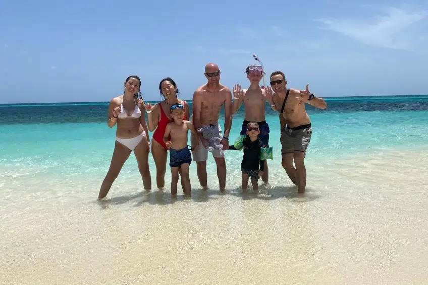 Group posing together in clear Bahia de las Aguilas waters