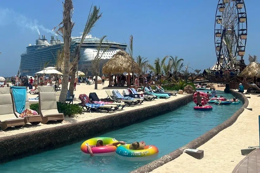 Guests floating on lazy river with cruise ship and Ferris wheel at Cabo Rojo Cruise Port
