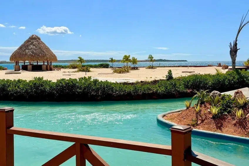 Lazy river winding past lounge chairs and thatched gazebos at Cabo Rojo Cruise Port