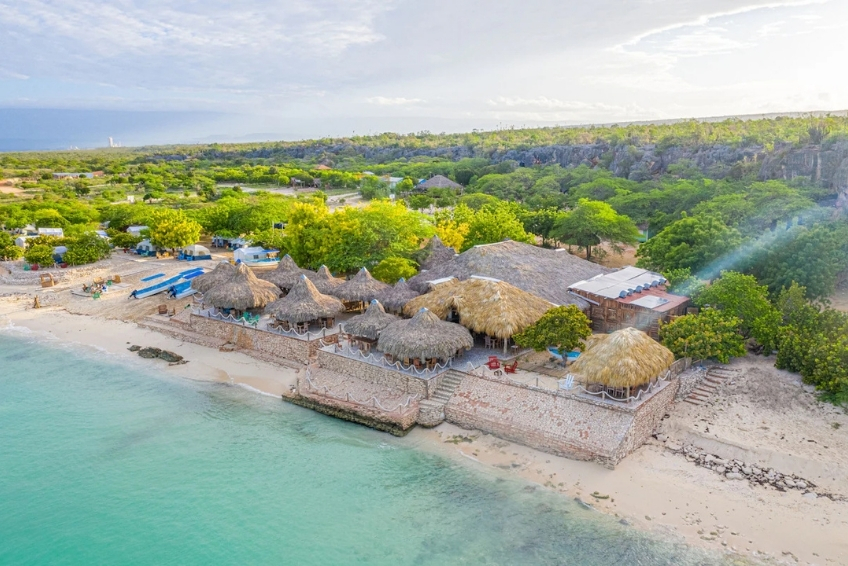 Where to Stay in Pedernales & Cabo Rojo - Glamping EcoLodge Cueva de las Aguilas View of beachfront Glamping EcoLodge Cueva de las Aguilas with thatched roof huts