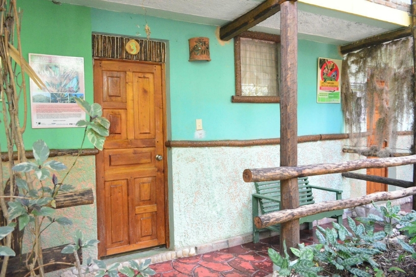 Rustic teal hostal room entrance at Hostal Dona Chava