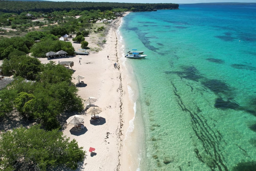 View of white sand beach with turquoise water at Hotel Casa Bajari