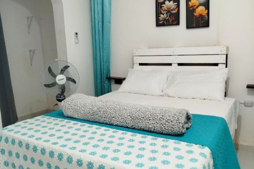 Room at Hotel El Almendro Clean white bedroom with teal floral bedding