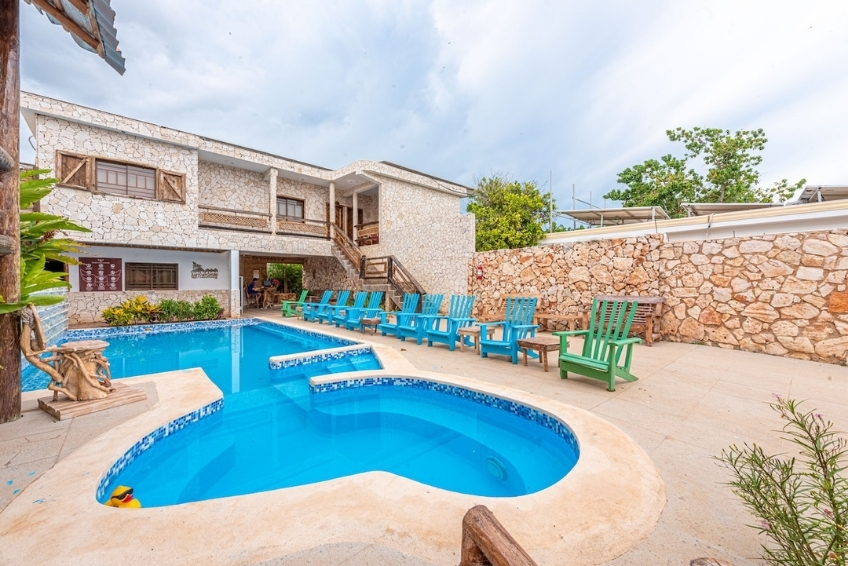 Hotel pool and attached children's pool with colorful lounge chairs at Hotel Vista de Aguilas Ecolodge