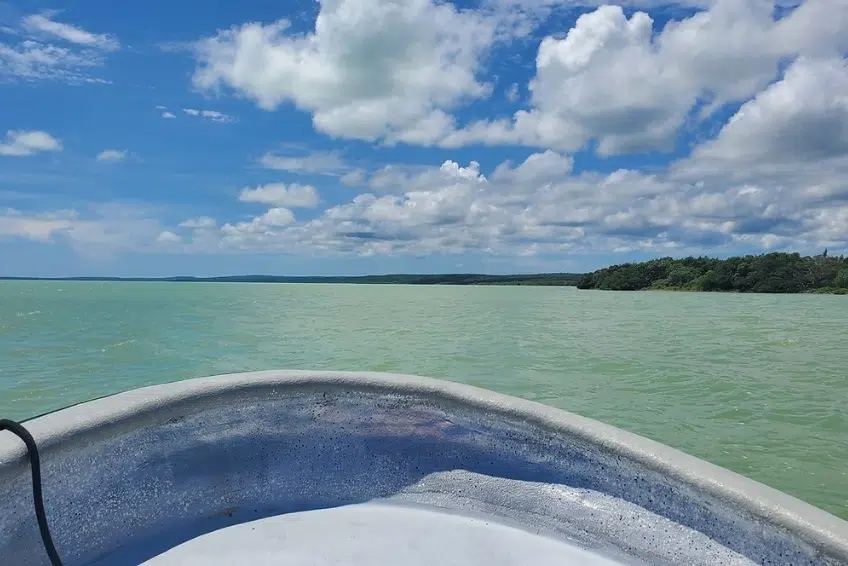 Boat bow view crossing open Laguna de Oviedo waters