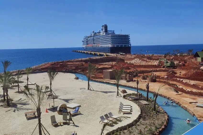 Cruise ship docked at pier beside beach and Cabo Rojo Cruise Port
