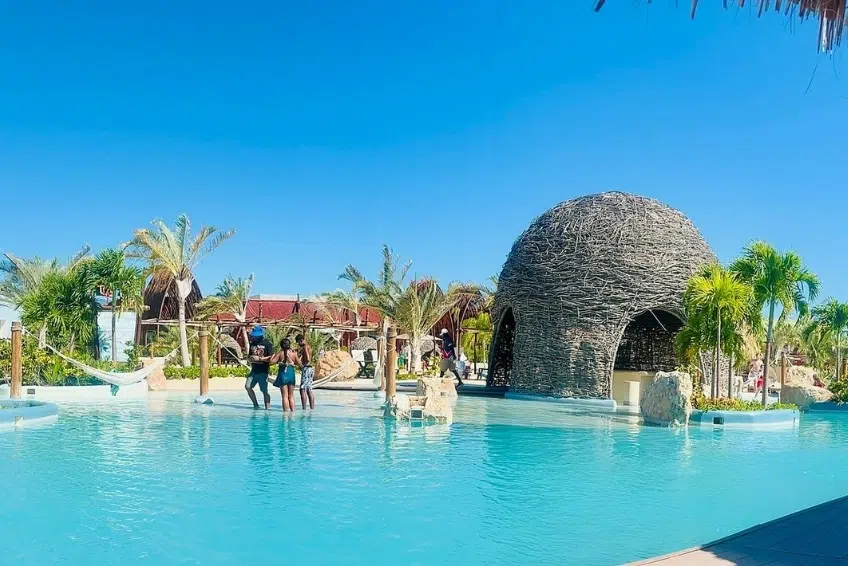 Pool area with woven dome structure and palm trees at Cabo Rojo Cruise Port