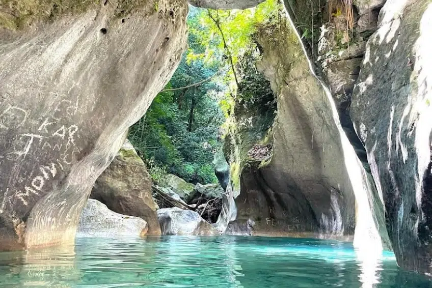 Turquoise natural pool inside smooth rock canyon in Barahona Province, DR