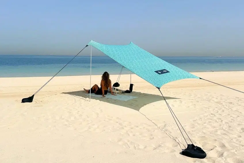 Relaxing under teal beach shade canopy on white sands in Cabo Rojo