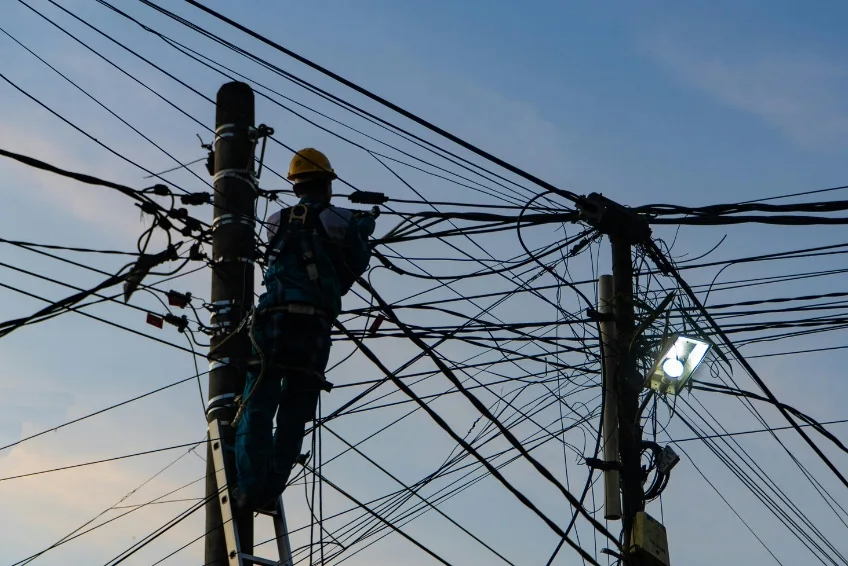 Lineman climbing utility pole to restore power