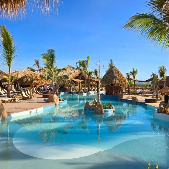 Where to Stay in Pedernales & Cabo Rojo - Coming Soon Lagoon-style resort pool with palm trees and thatched huts in Cabo Rojo, Dominican Republic