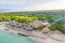 View of thatched beach lodge Glamping EcoLodge Cueva de las Aguilas in Cabo Rojo, DR