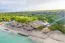 View of thatched beach lodge Glamping EcoLodge Cueva de las Aguilas in Cabo Rojo, DR
