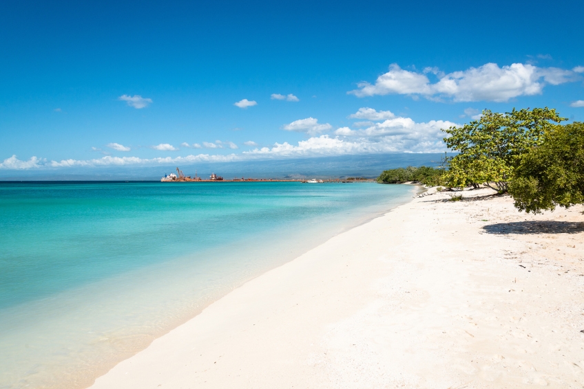 White sands of Baby Beach with turquoise water and trees
