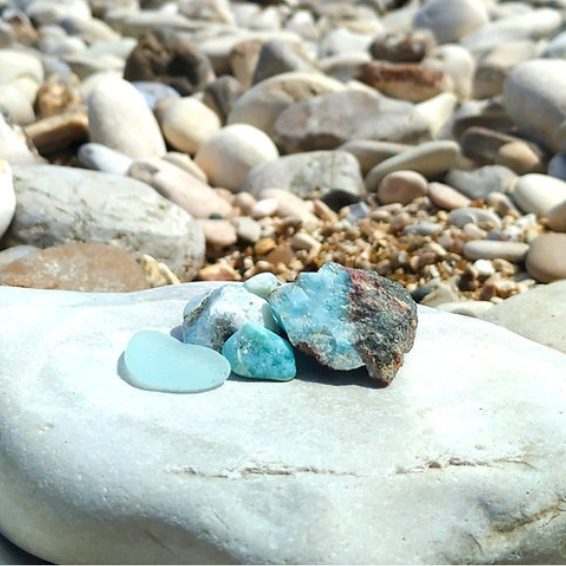 Natural Larimar stones resting on shoreline