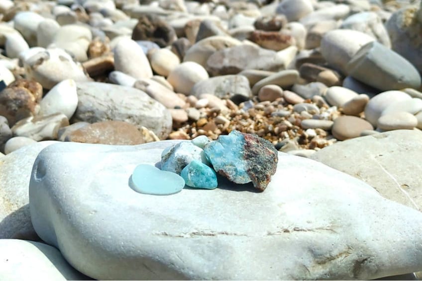 Natural Larimar stones resting on shoreline