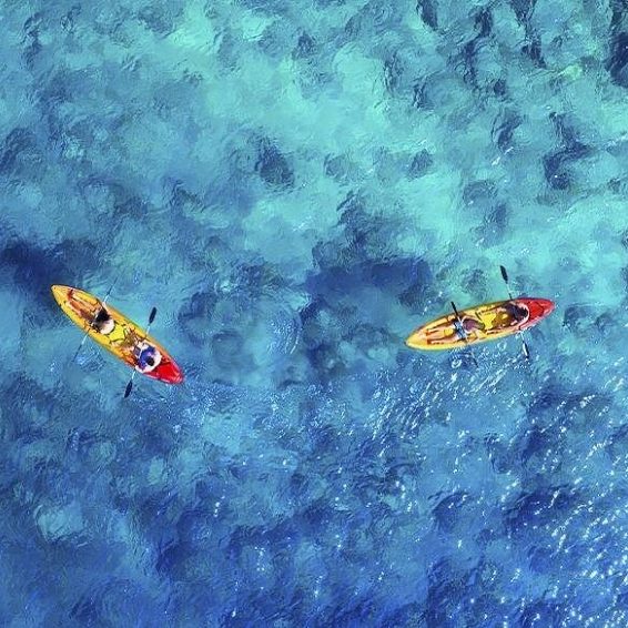 Kayakers paddling over turquoise waters in Cabo Rojo, Dominican Republic
