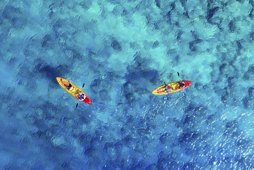 Kayakers paddling over turquoise waters in Cabo Rojo, Dominican Republic