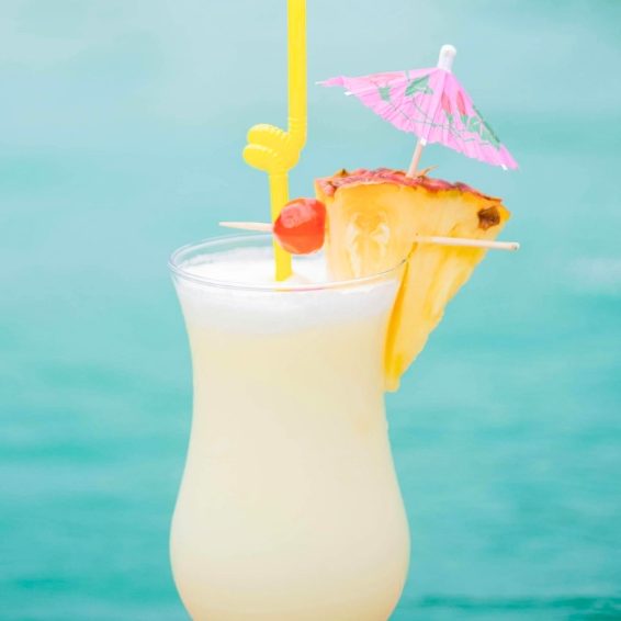 Tropical cocktail by the pool with pineapple and umbrella in Cabo Rojo