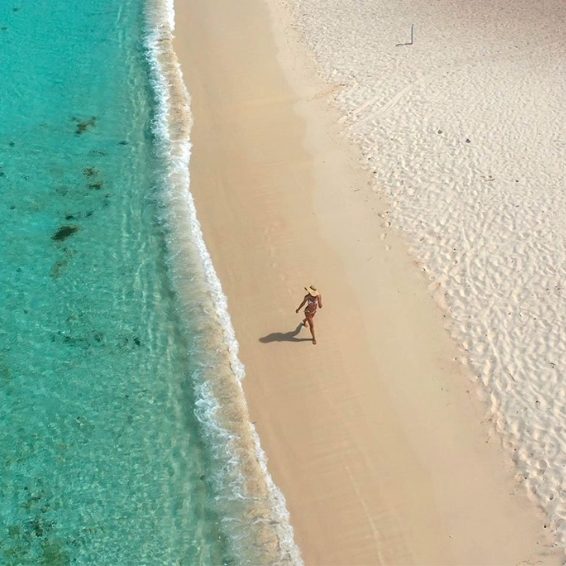 Solo traveler strolling pristine Bahia de las Aguilas beach