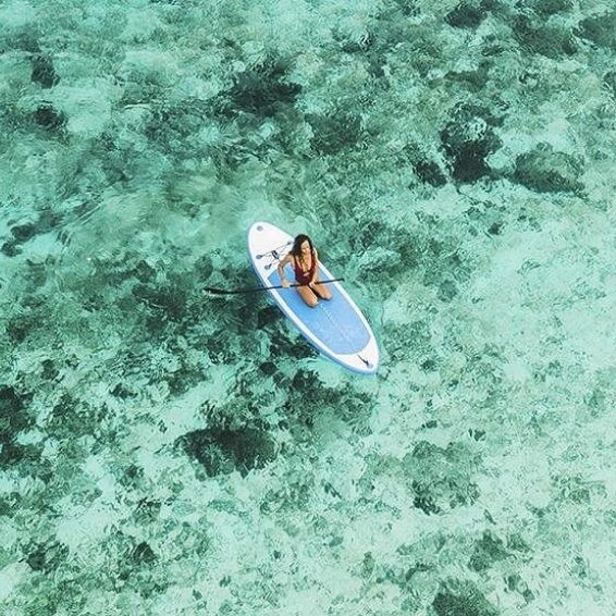 Paddleboarder over clear turquoise waters at Port Cabo Rojo, Dominican Republic