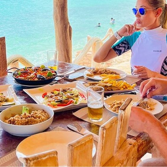 Dining on seafood spread at beachside restaurant Rancho Tipico Cueva de las Aguilas